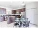 Kitchen with dark wood cabinets, granite countertops, and an island at 2501 Dharma Cir, Kissimmee, FL 34746
