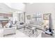 Open living room with light gray sofas, a large TV and coffee table at 2501 Dharma Cir, Kissimmee, FL 34746