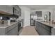 Modern kitchen with gray cabinets and granite countertops at 2522 Sage Valley Way, Winter Haven, FL 33884