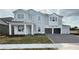 Two-story home featuring a light gray exterior, a brick paved driveway, and an attached two-car garage at 2726 Ravencliffe Ter, Oviedo, FL 32765