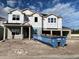 New two-story home construction featuring modern architectural design and a spacious two-car garage, awaiting finishing touches at 2726 Ravencliffe Ter, Oviedo, FL 32765