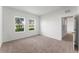 Bright bedroom featuring two windows and carpet flooring at 2823 Poppy Ave, Lake Hamilton, FL 33851