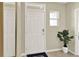 Bright entryway with a white door and a potted plant at 3440 Costello Cir, Winter Haven, FL 33884