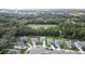 Houses on a residential street, with a large empty lot and surrounding trees at 3627 Crimson Clover Dr, Mount Dora, FL 32757