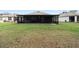 Spacious backyard with an enclosed lanai, perfect for outdoor entertaining and relaxation at 3627 Crimson Clover Dr, Mount Dora, FL 32757