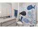 Clean bathroom with granite countertop, a shower/tub combo, and a playful shower curtain at 3627 Crimson Clover Dr, Mount Dora, FL 32757