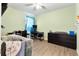 Cozy bedroom featuring calming green walls, a crib, and a well-organized workspace at 3627 Crimson Clover Dr, Mount Dora, FL 32757