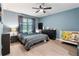 Comfortable bedroom with stylish decor, featuring a crib, dresser, and a serene ambiance at 3627 Crimson Clover Dr, Mount Dora, FL 32757