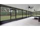 Large screened porch with ceiling fans, overlooking backyard at 3627 Crimson Clover Dr, Mount Dora, FL 32757
