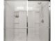 Modern shower featuring sleek sliding glass doors, built-in shelving, and a contemporary design at 3627 Crimson Clover Dr, Mount Dora, FL 32757