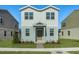 Two-story house with white and light gray siding, landscaping, and a paved walkway at 368 Belmond Dr, Debary, FL 32713