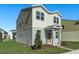 Two-story house with gray and beige siding, landscaping, and a paved walkway at 368 Belmond Dr, Debary, FL 32713