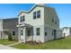Two-story house with gray and beige siding, landscaping, and a paved walkway at 368 Belmond Dr, Debary, FL 32713