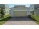 Attached garage with tan door and brick pavers at 368 Belmond Dr, Debary, FL 32713