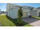 Attached garage with tan door, landscaping, and brick pavers at 368 Belmond Dr, Debary, FL 32713