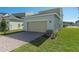 Attached garage with tan door, brick pavers, and landscaping at 368 Belmond Dr, Debary, FL 32713