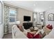 Living room with sectional sofa, wood floors, and large windows at 368 Belmond Dr, Debary, FL 32713