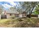 Large backyard featuring a patio, fire pit, lush greenery and mature trees at 512 Holbrook Cir, Lake Mary, FL 32746
