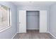 Light-filled bedroom featuring wood floors, closet, and a window for natural light at 512 Holbrook Cir, Lake Mary, FL 32746