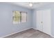 This bedroom features wood-look floors, a window with blinds, ceiling fan, and a double-door closet at 512 Holbrook Cir, Lake Mary, FL 32746