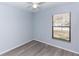 Bedroom featuring hardwood floors, a ceiling fan, and a window for natural light at 512 Holbrook Cir, Lake Mary, FL 32746