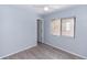 A well-lit bedroom with neutral walls, wood-look floors, and a window for natural light at 512 Holbrook Cir, Lake Mary, FL 32746