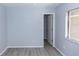 Bedroom with gray wood floors, light blue walls, and closet at 512 Holbrook Cir, Lake Mary, FL 32746