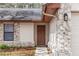 Inviting front entry featuring a stone facade, brown door, and well-maintained landscaping at 512 Holbrook Cir, Lake Mary, FL 32746