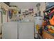 Laundry room with washer, dryer, and storage shelves at 5158 Twine St, Orlando, FL 32821