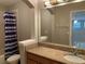 Bathroom boasts granite countertop and large mirror at 6344 Earthgold Dr, Windermere, FL 34786