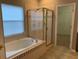 Main bath with soaking tub, shower, and walk-in closet at 6344 Earthgold Dr, Windermere, FL 34786