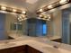 Double vanity bathroom with large mirror and modern light at 6344 Earthgold Dr, Windermere, FL 34786