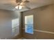 Well-lit bedroom featuring a window with blinds at 6344 Earthgold Dr, Windermere, FL 34786