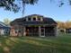 Tan house with large screened porch and fenced backyard at 6344 Earthgold Dr, Windermere, FL 34786