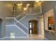 Two-story foyer with elegant staircase and high ceilings at 6344 Earthgold Dr, Windermere, FL 34786