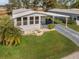 Single-wide manufactured home with carport and lush lawn at 6375 Lolly Bay Ne Loop, Winter Haven, FL 33881