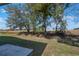 Backyard with grass, trees, and a concrete patio at 6375 Lolly Bay Ne Loop, Winter Haven, FL 33881