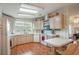 Galley-style kitchen with light wood cabinets, ample counter space, and modern appliances at 6375 Lolly Bay Ne Loop, Winter Haven, FL 33881