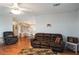 Living room with leather couches and wood floors at 6375 Lolly Bay Ne Loop, Winter Haven, FL 33881