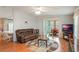 Bright living room with hardwood floors, comfortable seating, and sliding glass doors leading to patio at 6375 Lolly Bay Ne Loop, Winter Haven, FL 33881