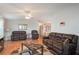 Living room with hardwood floors and leather furniture at 6375 Lolly Bay Ne Loop, Winter Haven, FL 33881