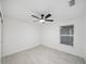 Bedroom with ceiling fan and large window at 6455 Hemlock Rd, Ocala, FL 34472