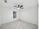 Simple bedroom with ceiling fan and tile floor at 6455 Hemlock Rd, Ocala, FL 34472