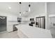 Modern kitchen with white cabinets, quartz countertops and stainless steel appliances at 6455 Hemlock Rd, Ocala, FL 34472