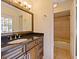 Bathroom vanity with dark granite countertop and warm neutral paint at 647 Saranac Dr, Winter Springs, FL 32708