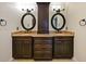 Bathroom featuring dual sinks, granite countertop, dark cabinetry, and bronze fixtures and hardware at 647 Saranac Dr, Winter Springs, FL 32708