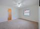Spacious bedroom with neutral carpet and a ceiling fan, perfect for relaxation at 647 Saranac Dr, Winter Springs, FL 32708