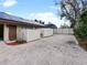 Wide driveway leading to the home, featuring solar panels and a privacy fence at 647 Saranac Dr, Winter Springs, FL 32708