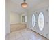 Bright entryway with tile flooring and double doors leading to a carpeted living space at 647 Saranac Dr, Winter Springs, FL 32708