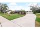 Charming single-Gathering home with solar panels, a well-manicured lawn, and a long driveway at 647 Saranac Dr, Winter Springs, FL 32708